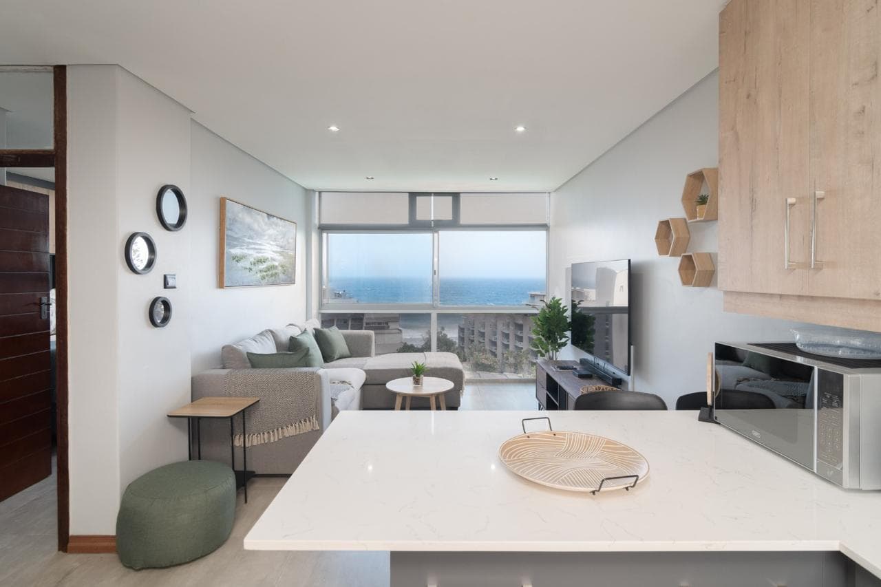 Bright living area with comfortable seating and stunning ocean views through floor-to-ceiling windows