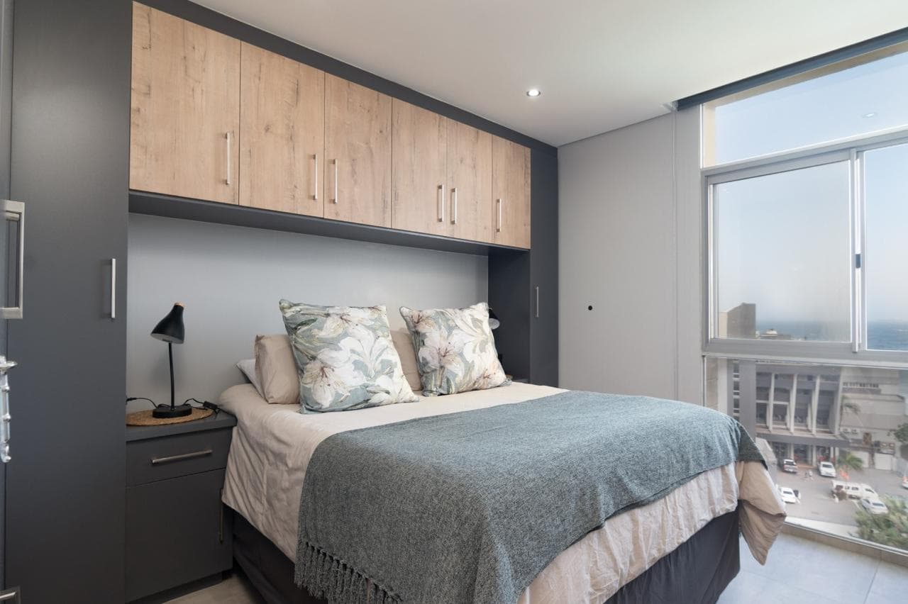 Comfortable main bedroom with queen-size bed and ample storage